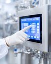 Hand in a white glove interacting with a digital touchscreen control panel in a modern industrial setting, showcasing Royalty Free Stock Photo