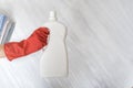 Gloved hand holding a big white bottle. Washing concept Royalty Free Stock Photo