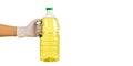 Gloved hand holding bottle of sunflower oil isolated on white background. Concept of hygienic cooking, safe shopping Royalty Free Stock Photo