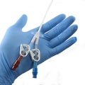 Gloved hand holding a catheter Royalty Free Stock Photo