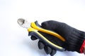 Gloved hand holding cutting pliers Royalty Free Stock Photo