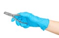 Gloved hand holding a pliers to remove teeth