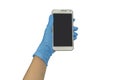 Gloved hand holding smart phone on white background.