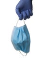 Gloved hand holding a surgical mask Royalty Free Stock Photo