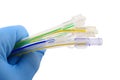 Gloved hand holding surgical tubing