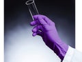 Gloved hand holds test tube filled with clear liquid