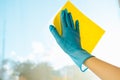 A gloved hand holds a yellow sponge Royalty Free Stock Photo