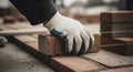 Gloved Hand Laying Bricks in Row on Concrete Surface Royalty Free Stock Photo