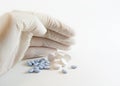 Gloved hand and medicinal pills Royalty Free Stock Photo