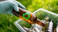 Gloved hand placing glass bottle into recycling container, waste sorting and sustainability concept Royalty Free Stock Photo