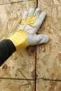 Gloved Hand and Plywood Wall Royalty Free Stock Photo