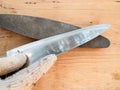 Gloved hand sharpens a kitchen knife closeup Royalty Free Stock Photo