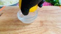 A gloved hand squeezes lemon juice.