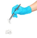 Gloved hand takes tweezers sterile cotton swab