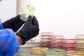 Gloved Hand of a Technician or scientist working with petri dish in microbiology laboratory. Bacterial Culture Media Royalty Free Stock Photo