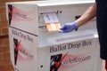 Gloved hand voting to protect voter from Coronavirus