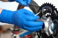 Gloved hands guy repair mechanical part bicycle