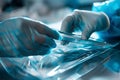 Gloved hands handling sterile surgical instruments within a protective packaging Royalty Free Stock Photo
