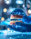 Gloved hands hold dentures with a high-tech frame, in a dentalsurgical setting Royalty Free Stock Photo