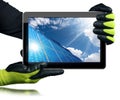 Gloved hands Holding a Digital Tablet Computer with Solar Panels Royalty Free Stock Photo