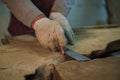 Gloved hands measure timber, a crucial step. It reflects the meticulous nature of sustainable wood sourcing.