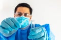 Gloved hands with swab and test tube approaching nose to take medical sample Royalty Free Stock Photo