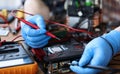 Gloved hands, on table repair an electronic device Royalty Free Stock Photo
