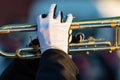 Gloved hands of a trumpet player in a marching band Royalty Free Stock Photo