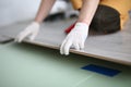 Gloved technician lays down laminate on backing Royalty Free Stock Photo