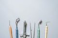 Gloves, dental mirror, anesthesia syringe, probes, tweezers on a blue background. Flat lay, copy space