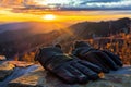 gloves resting on a stone wall, sunset background Royalty Free Stock Photo