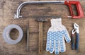 Gloves, saw, tape, hammer on the table Royalty Free Stock Photo