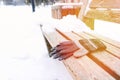 gloves on a wooden bench on a cold winter day