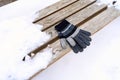 gloves on a wooden bench on a cold winter day