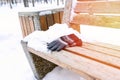 gloves on a wooden bench on a cold winter day