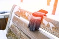 gloves on a wooden bench on a cold winter day