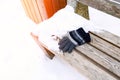 gloves on a wooden bench on a cold winter day