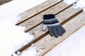 gloves on a wooden bench on a cold winter day