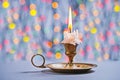 Gloving candle in vintage candlestick on background of bokeh