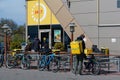 Glovo bicycle couriers and cars near McDonalds fast food restaurant