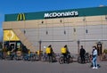 Glovo couriers and people near McDonalds fast food restaurant