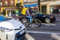 Glovo rider in between traffic after the company was fined again for infringement of labour laws, Madrid Spain