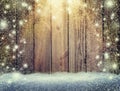 Glow of festive lights and a wooden background in the snow Royalty Free Stock Photo