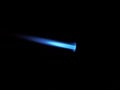 The glow of a gas lighter torch in the dark Royalty Free Stock Photo