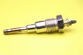 Glow plugs for diesel engine on yellow background. Glow plug which is spare part for automobiles. Single type glow plug