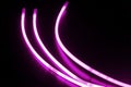 Glow sticks of purple on a black surface