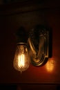 A glowing antique light fixture on a wall