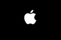 Glowing Apple logo on black background Royalty Free Stock Photo