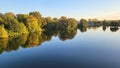 Glowing autumn trees with autumnal reflections