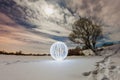 Glowing ball on the surface of a frozen lake